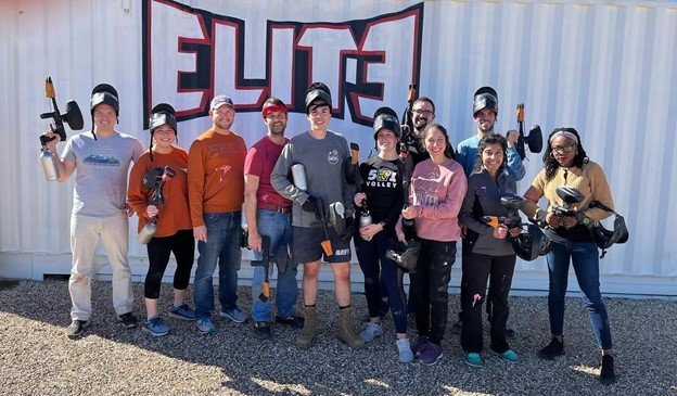 Surgery residents in painball gear standing infront of a metal wall Surgery residents in painball gear standing infront of a metal wall