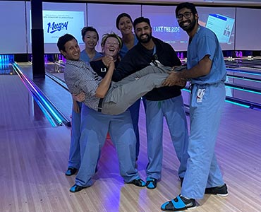 residents gathered on bowling alley lane smiling residents gathered on bowling alley lane smiling