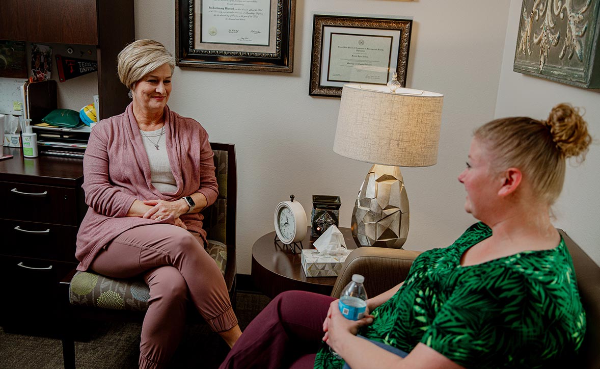 provider sitting with a patient provider sitting with a patient